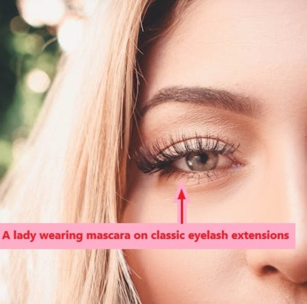A lady wearing mascara on classic eyelash extensions